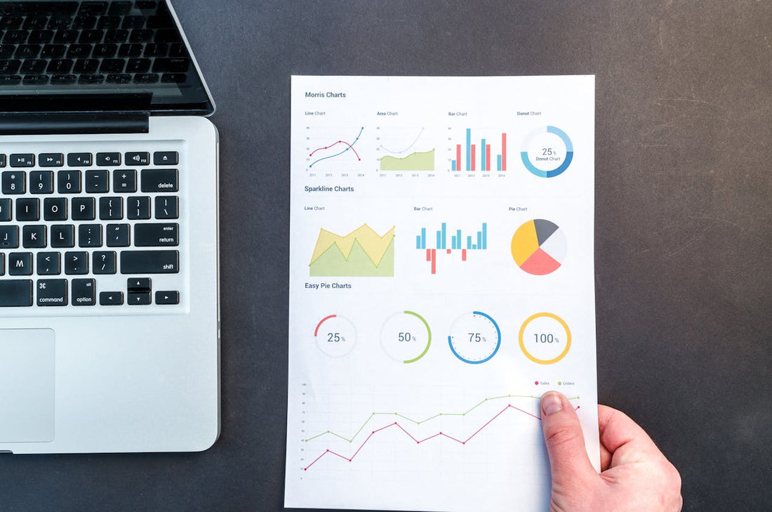 Personne tenant une feuille contenant des données graphiques et analytiques. 